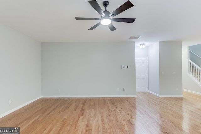 2725 Sedgeview Way, Buford, GA 30519 - empty room with ceiling fan, light wood finished floors, stairway, and baseboards