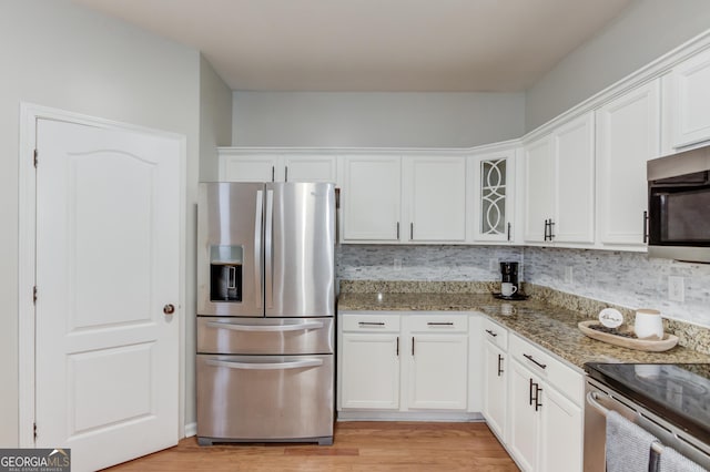 2725 Sedgeview Way, Buford, GA 30519 - kitchen with appliances with stainless steel finishes, white cabinetry, stone counters, and tasteful backsplash