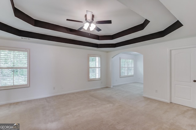 2725 Sedgeview Way, Buford, GA 30519 - spare room featuring ceiling fan, a raised ceiling, light colored carpet, arched walkways, and baseboards