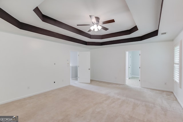 2725 Sedgeview Way, Buford, GA 30519 - spare room featuring a tray ceiling, a ceiling fan, light colored carpet, and baseboards