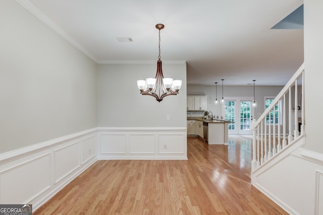 2725 Sedgeview Way, Buford, GA 30519 - spare room featuring light wood-type flooring, a chandelier, a wainscoted wall, a sink, and stairway