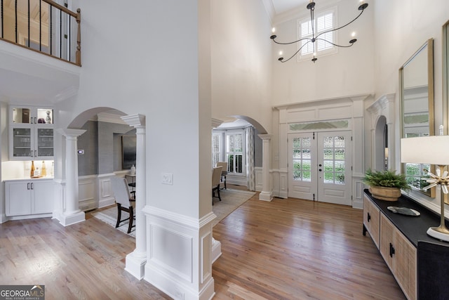 2101 Hunters Green Dr, Lawrenceville, GA 30043 - foyer featuring a decorative wall, healthy amount of natural light, arched walkways, a high ceiling, and a chandelier