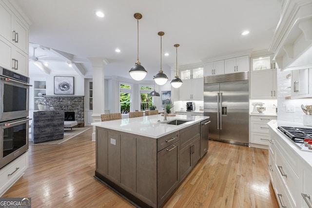 2101 Hunters Green Dr, Lawrenceville, GA 30043 - kitchen featuring appliances with stainless steel finishes, a sink, white cabinets, light countertops, and recessed lighting