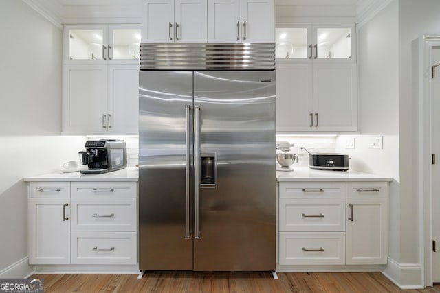 2101 Hunters Green Dr, Lawrenceville, GA 30043 - kitchen featuring built in fridge, light countertops, white cabinetry, and light wood-style flooring