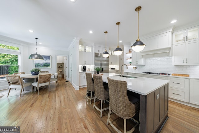 2101 Hunters Green Dr, Lawrenceville, GA 30043 - kitchen with a sink, stainless steel built in fridge, light countertops, backsplash, and a center island with sink
