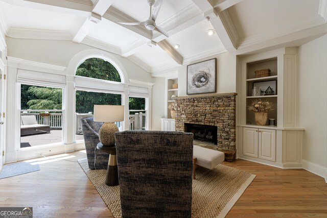 2101 Hunters Green Dr, Lawrenceville, GA 30043 - living room with ceiling fan, a stone fireplace, light wood-type flooring, built in features, and baseboards