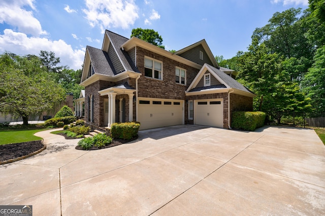 2101 Hunters Green Dr, Lawrenceville, GA 30043 - craftsman house with brick siding, an attached garage, concrete driveway, and a shingled roof