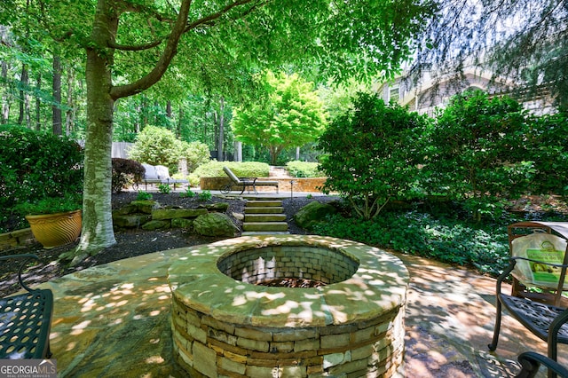 2101 Hunters Green Dr, Lawrenceville, GA 30043 - view of property's community with an outdoor fire pit and a patio