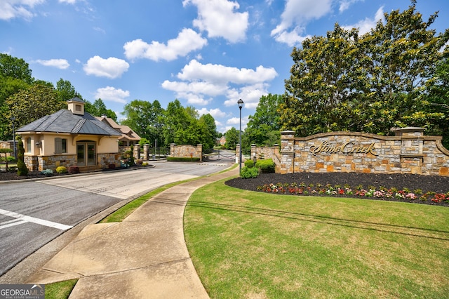 2101 Hunters Green Dr, Lawrenceville, GA 30043 - view of asphalt street featuring street lighting, sidewalks, a gated entry, curbs, and a gate