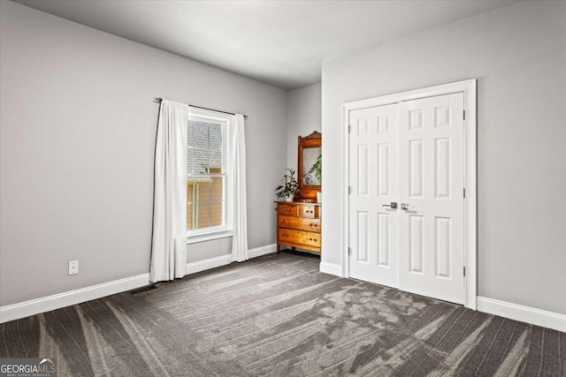 4251 Lantern Hill Dr, Dacula, GA 30019 - unfurnished bedroom with dark carpet, baseboards, and a closet