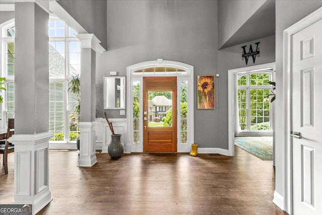 4251 Lantern Hill Dr, Dacula, GA 30019 - entryway featuring a towering ceiling, wood finished floors, ornate columns, and baseboards