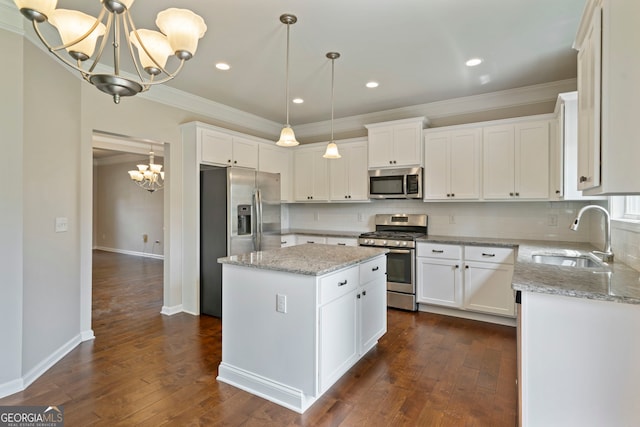 4650 Pleasant Woods Dr, Cumming, GA 30028 - kitchen featuring stainless steel appliances, a chandelier, a sink, ornamental molding, and dark wood-style floors