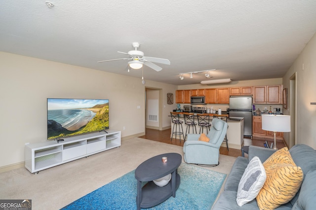 1523 Gadwall Way, Seneca, SC 29678 - living area featuring ceiling fan, light colored carpet, a textured ceiling, and baseboards