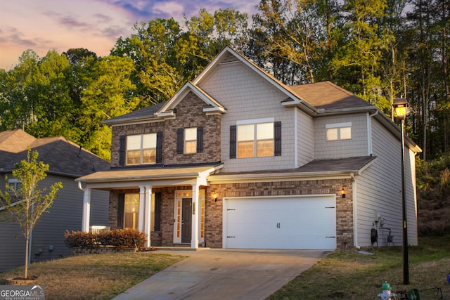 5229 Tye Trl, Fairburn, GA 30213 - view of front facade with driveway, a garage, covered porch, a front lawn, and brick siding