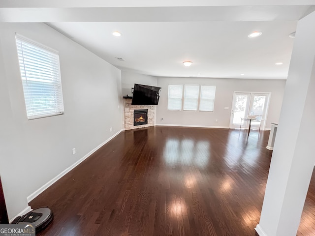 5229 Tye Trl, Fairburn, GA 30213 - unfurnished living room featuring dark wood finished floors, a stone fireplace, baseboards, and recessed lighting