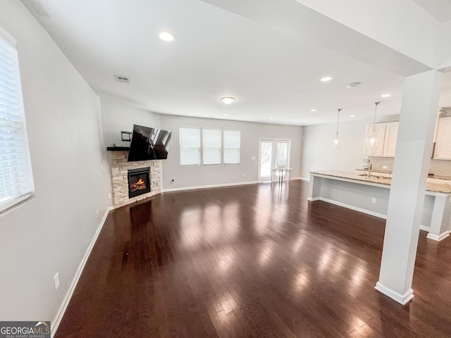 5229 Tye Trl, Fairburn, GA 30213 - unfurnished living room featuring dark wood finished floors, a fireplace, baseboards, recessed lighting, and a sink