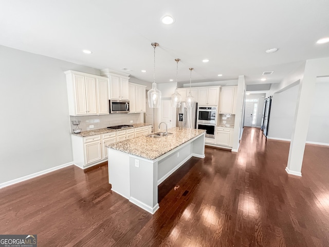 5229 Tye Trl, Fairburn, GA 30213 - kitchen featuring appliances with stainless steel finishes, a sink, backsplash, dark wood-style flooring, and recessed lighting
