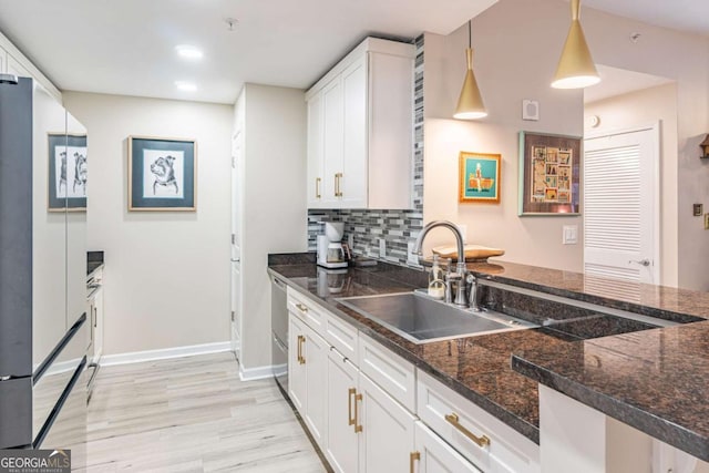 3040 Peachtree Rd NW Unit 1013, Atlanta, GA 30305 - kitchen with a sink, freestanding refrigerator, light wood-type flooring, white cabinets, and baseboards