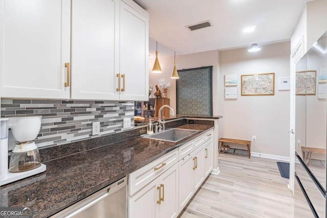 3040 Peachtree Rd NW Unit 1013, Atlanta, GA 30305 - kitchen with a sink, white cabinetry, decorative backsplash, light wood-style floors, and dark stone counters