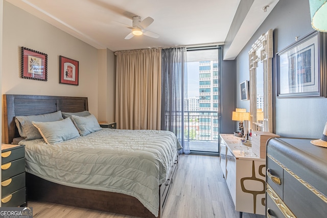 3040 Peachtree Rd NW Unit 1013, Atlanta, GA 30305 - bedroom featuring a wall of windows, light wood-type flooring, access to exterior, and ceiling fan