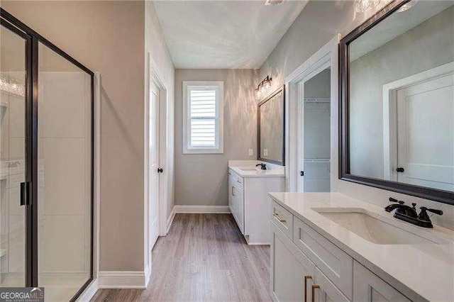 349 Creek Wood Park Dr, Ball Ground, GA 30107 - full bath with a stall shower, wood finished floors, and two vanities
