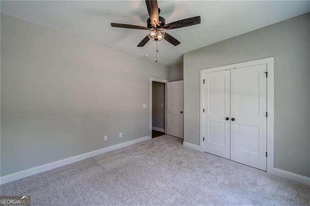 349 Creek Wood Park Dr, Ball Ground, GA 30107 - unfurnished bedroom featuring carpet, a closet, and ceiling fan