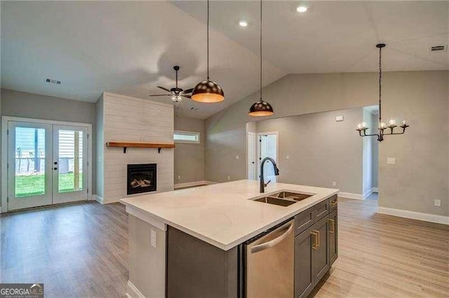 349 Creek Wood Park Dr, Ball Ground, GA 30107 - kitchen featuring dishwasher, vaulted ceiling, light wood-type flooring, light countertops, and open floor plan