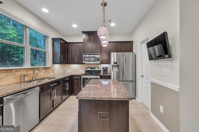 3982 Brockenhurst Dr, Buford, GA 30519 - kitchen with stainless steel appliances, a sink, light stone countertops, light wood-type flooring, and dark brown cabinets