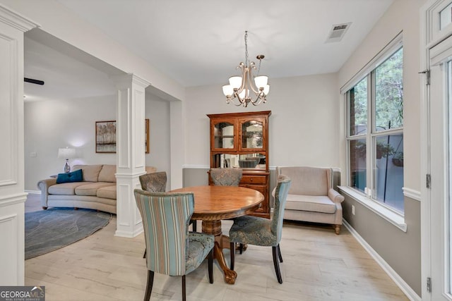 3982 Brockenhurst Dr, Buford, GA 30519 - dining space with ornate columns, light wood-type flooring, and a chandelier