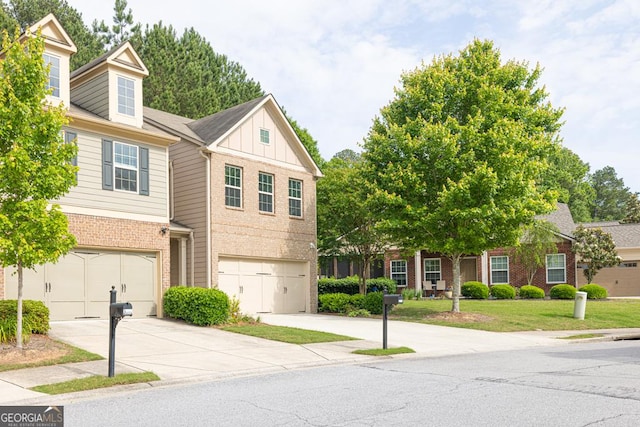 3982 Brockenhurst Dr, Buford, GA 30519 - townhome / multi-family property with brick siding, board and batten siding, driveway, a front yard, and a garage