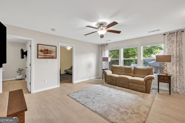 3982 Brockenhurst Dr, Buford, GA 30519 - living area with ceiling fan, light wood-style flooring, baseboards, and stairs