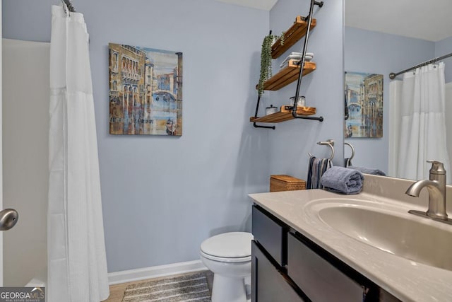 3982 Brockenhurst Dr, Buford, GA 30519 - bathroom featuring toilet, vanity, a shower with curtain, and baseboards