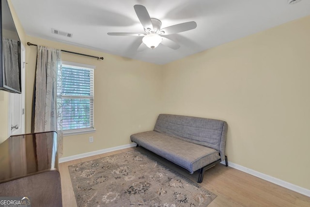 3982 Brockenhurst Dr, Buford, GA 30519 - living area featuring ceiling fan, wood finished floors, and baseboards