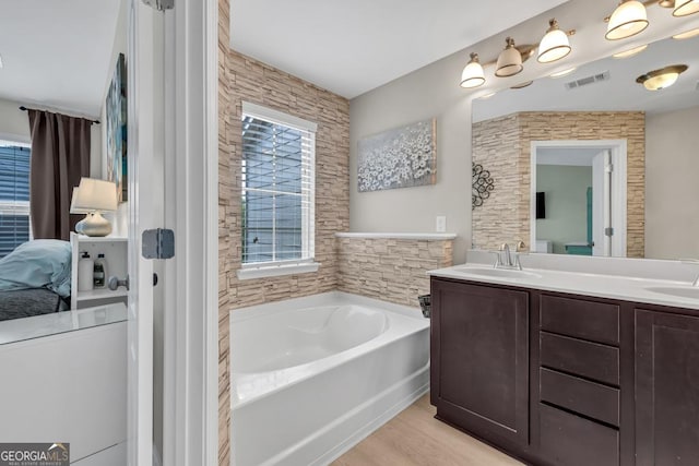 3982 Brockenhurst Dr, Buford, GA 30519 - full bathroom featuring a bath, plenty of natural light, double vanity, and wood finished floors