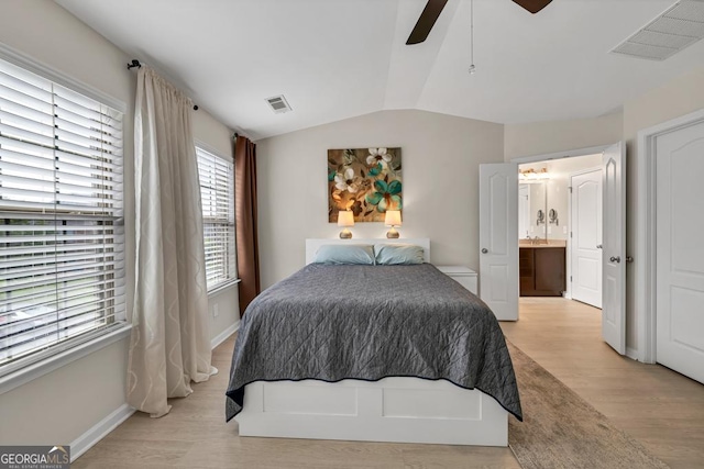 3982 Brockenhurst Dr, Buford, GA 30519 - bedroom featuring vaulted ceiling, light wood-style flooring, baseboards, ceiling fan, and ensuite bathroom