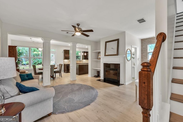 3982 Brockenhurst Dr, Buford, GA 30519 - living area featuring stairway, ornate columns, plenty of natural light, and ceiling fan