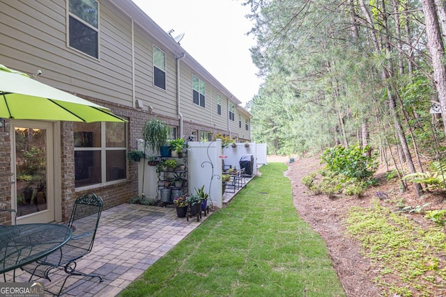 3982 Brockenhurst Dr, Buford, GA 30519 - view of grassy yard with a patio area