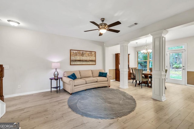 3982 Brockenhurst Dr, Buford, GA 30519 - living area featuring ornate columns, light wood-style flooring, and a chandelier