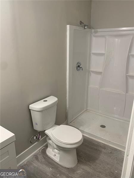 747 Harrold, Macon, GA 31201 - bathroom with vanity, wood finished floors, a shower, and toilet