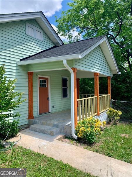 747 Harrold, Macon, GA 31201 - doorway to property featuring covered porch and a shingled roof