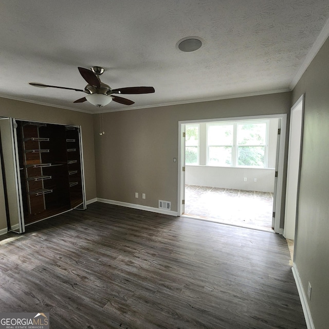 3140 Kipling Dr, Powder Springs, GA 30127 - empty room with ornamental molding, dark wood-style floors, a ceiling fan, and a textured ceiling