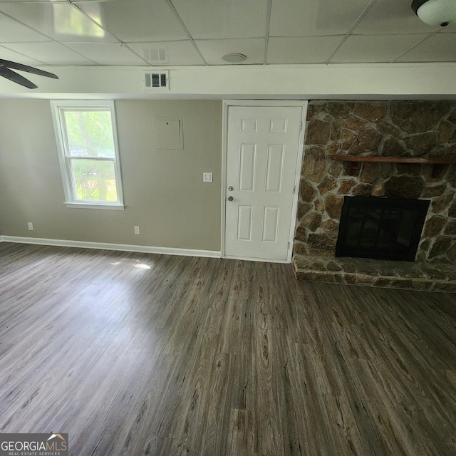 3140 Kipling Dr, Powder Springs, GA 30127 - unfurnished living room with a paneled ceiling, wood finished floors, a stone fireplace, and a ceiling fan