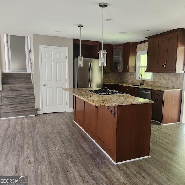 3140 Kipling Dr, Powder Springs, GA 30127 - kitchen with stainless steel appliances, dark wood-style floors, a center island, decorative backsplash, and hanging light fixtures