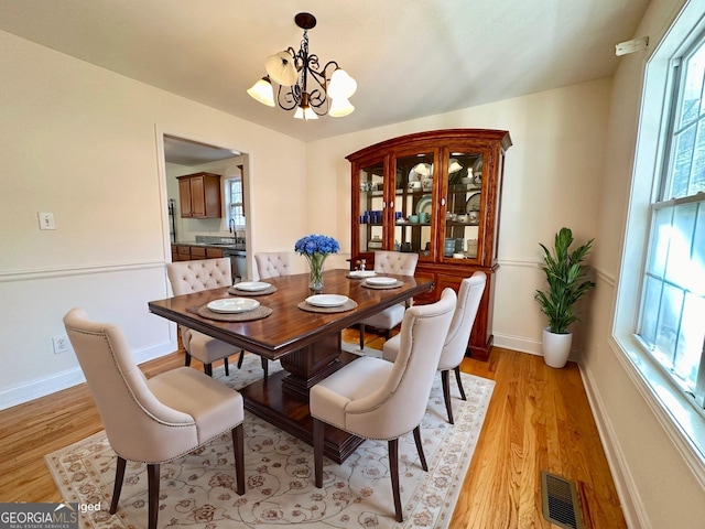 119 E Surry Ct, Athens, GA 30606 - dining room featuring a chandelier and light wood finished floors