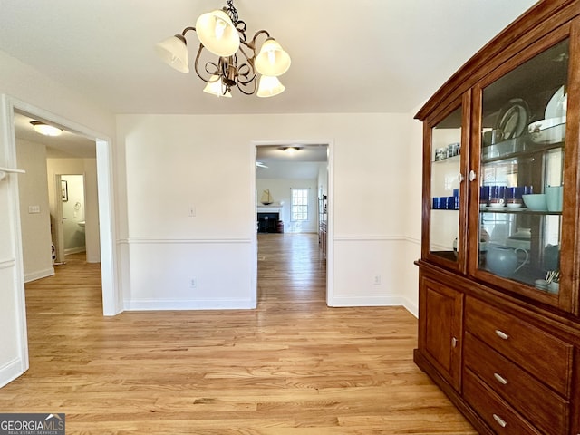 119 E Surry Ct, Athens, GA 30606 - unfurnished dining area with a chandelier, light wood-style floors, and baseboards