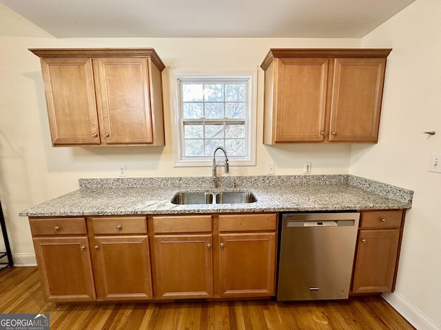 119 E Surry Ct, Athens, GA 30606 - kitchen with stainless steel dishwasher, dark wood finished floors, light stone countertops, and brown cabinetry