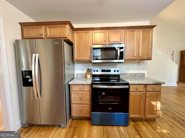 119 E Surry Ct, Athens, GA 30606 - kitchen with appliances with stainless steel finishes, light wood-type flooring, light stone countertops, and brown cabinets