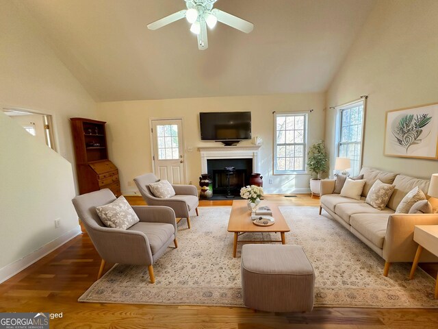119 E Surry Ct, Athens, GA 30606 - living room featuring a ceiling fan, wood finished floors, a fireplace with flush hearth, and high vaulted ceiling