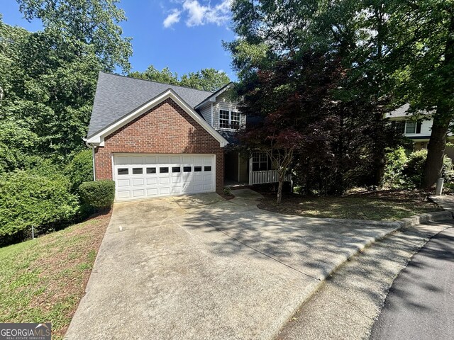 119 E Surry Ct, Athens, GA 30606 - traditional-style house featuring brick siding, driveway, an attached garage, and a shingled roof