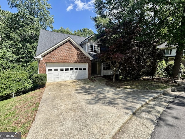 119 E Surry Ct, Athens, GA 30606 - traditional-style house featuring brick siding, concrete driveway, an attached garage, and a shingled roof